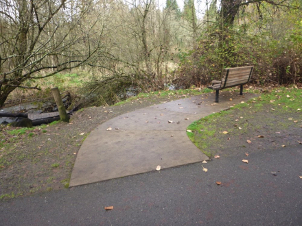 Hard surface trail &ndash; bench overlooking Salmon Creek &ndash; gravel on the side of path